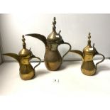 THREE MIDDLE EASTERN DALLAH BRASS COFFEE POTS, THE LARGEST 40CMS