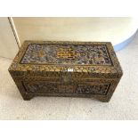 HEAVILY CARVED CAMPHOR CHEST DECORATED ORIENTAL STYLE WITH DRAGONS WITH THE INTERNAL SHELF