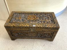 HEAVILY CARVED CAMPHOR CHEST DECORATED ORIENTAL STYLE WITH DRAGONS WITH THE INTERNAL SHELF