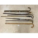 EIGHT VARIOUS WALKING STICKS, INCLUDING ONE WITH HIKERS LABELS AND HORN HANDLES