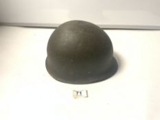 A MILITARY HELMET WITH LINER PRINTED TO CHIN STRAP - M.W.S 1987 973-6537