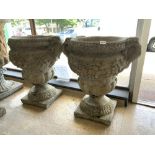 A LARGE PAIR OF 20TH CENTURY STONE GARDEN URNS WITH HANDLES WITH ACANTHUS LEAF, SWAG, AND FLORAL