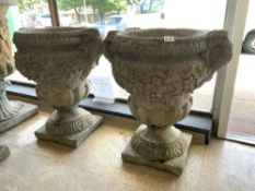 A LARGE PAIR OF 20TH CENTURY STONE GARDEN URNS WITH HANDLES WITH ACANTHUS LEAF, SWAG, AND FLORAL