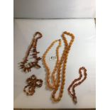 FIVE AMBER-COLOURED NECKLACES