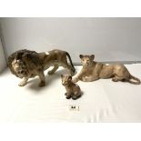 MELBA WARE CERAMIC FIGURES OF MALE LION, LIONESS, AND A CUB, THE LARGEST 36 X 20CMS