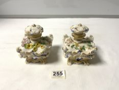A PAIR OF CONTINENTAL PORCELAIN INK POTS WITH STOPPERS AND FLORAL ENCRUSTED DECORATION (A/F)