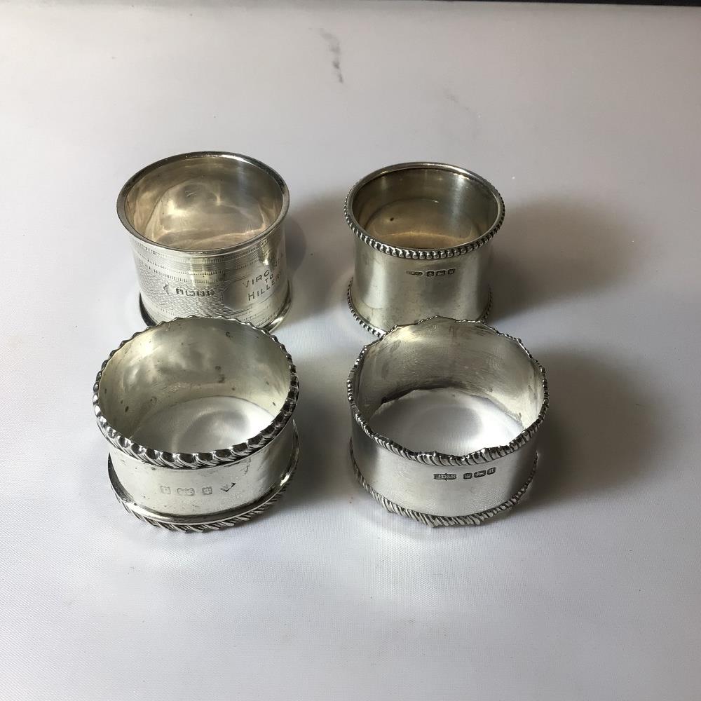 FOUR HALLMARKED SILVER ENGRAVED NAPKIN RINGS