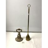 A VICTORIAN CAST IRON DOOR STOP, AND A LONG HANDLED BRASS DOOR STOP