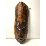 A LARGE CARVED AFRICAN WOODEN WALL MASK WITH CROCODILE-EATING TURTLE DECORATION 80CMS