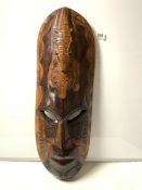 A LARGE CARVED AFRICAN WOODEN WALL MASK WITH CROCODILE-EATING TURTLE DECORATION 80CMS