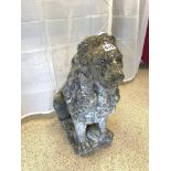 A STONE FIGURE OF A SEATED LION