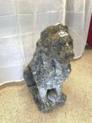 A STONE FIGURE OF A SEATED LION