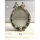 GERMAN PORCELAIN OVAL MIRROR WITH MOUNTED CHERUBS AND FLORAL ENCRUSTED DECORATION (SOME FAULTS)