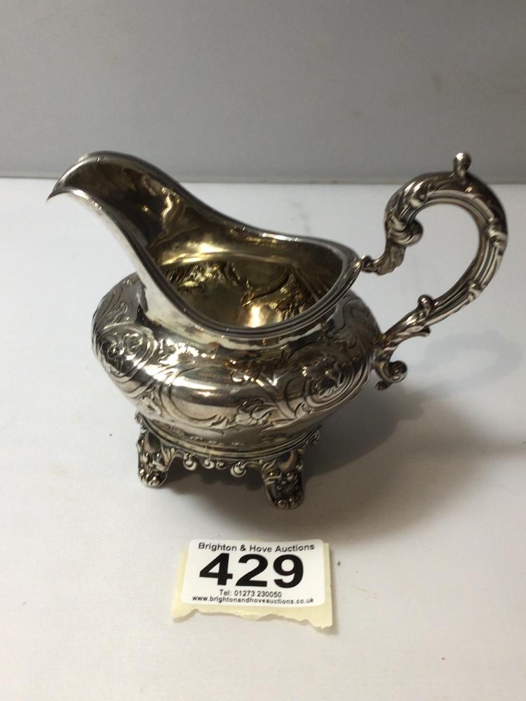 EARLY VICTORIAN HALLMARKED SILVER EMBOSSED CIRCULAR CREAM JUG, WITH SCROLL HANDLE ON SHELL DECORATED - Image 2 of 3