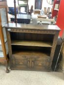 A CARVED DISTRESSED OAK DWARF BOOKCASE WITH CUPBOARD UNDER, 84 X 92CMS
