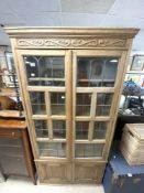 1930S OAK LEADED LIGHT FOUR-DOOR BOOKCASE WITH A CARVED FREEZE, 96 X 26 X 188CMS