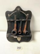 EBONISED PIPE RACK WITH HALLMARKED SILVER SHIELD LONDON 1900, MOUNTED AND SILVER PIPE DECORATION
