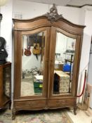 A LATE 19TH CENTURY FRENCH OAK ARMOIRE WITH DOUBLE MIRRORED DOORS WITH TWO DRAWERS AND CARVED