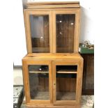 A TALL GLAZED PINE FOUR-DOOR BOOKCASE, 96 X 258CMS