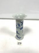 A 20TH CENTURY CHINESE BLUE AND WHITE TRUMPET VASE DECORATED WITH FIGURES AND TREES, 20CMS