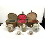 THREE EARLY 20TH CENTURY CHINESE CANTON TEAPOTS IN FITTED CANE CASES