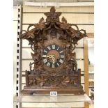 A 19TH CARVED OAK BLACK FOREST BRACKET CUCKOO CLOCK WITH CARVED LEAF AND GRAPE DECORATION - DOUBLE