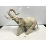 A PAINTED METAL FIGURE OF AN ELEPHANT, 42CMS