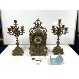EARLY 20TH CENTURY FRENCH HIGHLY ORNATE BRASS CLOCK GARNITURE COMPRISING OF CLOCK AND A PAIR OF
