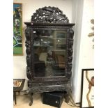 A LATE 19TH CENTURY/EARLY 20TH CENTURY ORIENTAL BLACK CARVED DISPLAY CABINET WITH EXOTIC BIRD, A