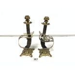 A PAIR OF SWORD GRIP AND GUARD CONVERTED TO CANDLESTICKS, 28CMS