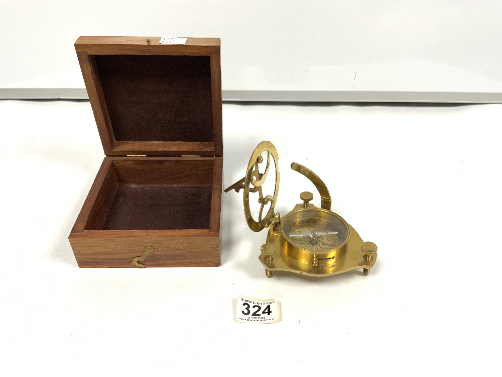 A REPRODUCTION BRASS MARINE COMPASS/SUN DIAL IN A MAHOGANY BOX
