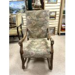 LOUIS XIII STYLE ELBOW CHAIR WITH CARVED LIONS HEAD ARMS AND NEEDLEPOINT UPHOLSTERY AND CROSS