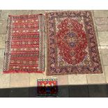 PERSIAN RED GROUND PATTERNED RUG (SOME MINOR WEAR) 142 X 202CMS, A PERSIAN WOOLLEN RUG, AND A