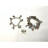 TWO CHARM BRACELETS ONE STERLING/WHITE METAL WITH 56 CHARMS, 102 GRAMS