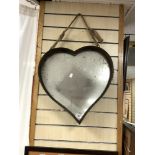 A METAL FRAMED HEART-SHAPED WALL MIRROR