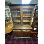 A LATE VICTORIAN MAHOGANY AND WALNUT GLAZED BOOKCASE WITH TWO DRAWERS AND DOORS UNDER, 101 X 41 X