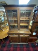 A LATE VICTORIAN MAHOGANY AND WALNUT GLAZED BOOKCASE WITH TWO DRAWERS AND DOORS UNDER, 101 X 41 X