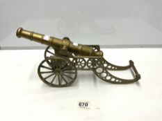 A BRASS CANNON ON CARRIAGE