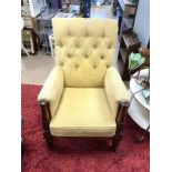 VICTORIAN UPHOLSTERED BUTTON-BACK ARMCHAIR WITH CARVED MAHOGANY ACANTHUS LEGS ON METAL CASTORS