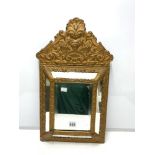 LATE 19TH CENTURY EMBOSSED BRASS CUSHION MIRROR BEVELLED, 58 X 32CMS