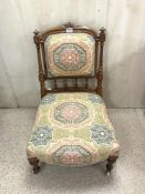 VICTORIAN MAHOGNAY UPHOLSTERED NURSING CHAIR WITH TURNED SUPPORTS AND PORCELAIN CASTORS