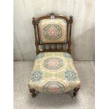 VICTORIAN MAHOGNAY UPHOLSTERED NURSING CHAIR WITH TURNED SUPPORTS AND PORCELAIN CASTORS