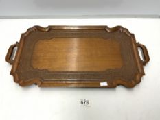 A CARVED EASTERN TWO HANDLE WOODEN TRAY