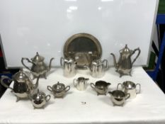 TWO SILVER-PLATED TEA AND COFFEE SETS AND A CIRCULAR PLATED TRAY