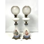A PAIR OF OPALINE GLASS - NAPOLEAN AND JOSEPHINE PORTRAIT TABLE OIL LAMPS, WITH ORNATE CAST BRASS