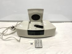 A WHITE BOSE RADIO WAVE/CD PLAYER WITH REMOTE