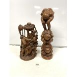 AN AFRICAN CARVED GROUP OF WORKING FIGURES, 39CMS AND A BALANESE FIGURE TOTUM STYLE FIGURE, 52CMS