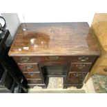 GEORGIAN MAHOGANY SEVEN DRAWER KNEEHOLE DESK WITH CUPBOARD UNDER, ON BRACKET FEET WITH BRASS SWAN