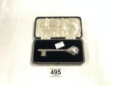 A WHITE METAL PRESENTATION KEY IN FITTED CASE