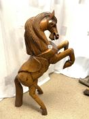 A CARVED WOODEN MODEL OF A PRANCING HORSE,124CMS